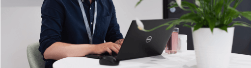 An image of a IT Admin working on their laptop
