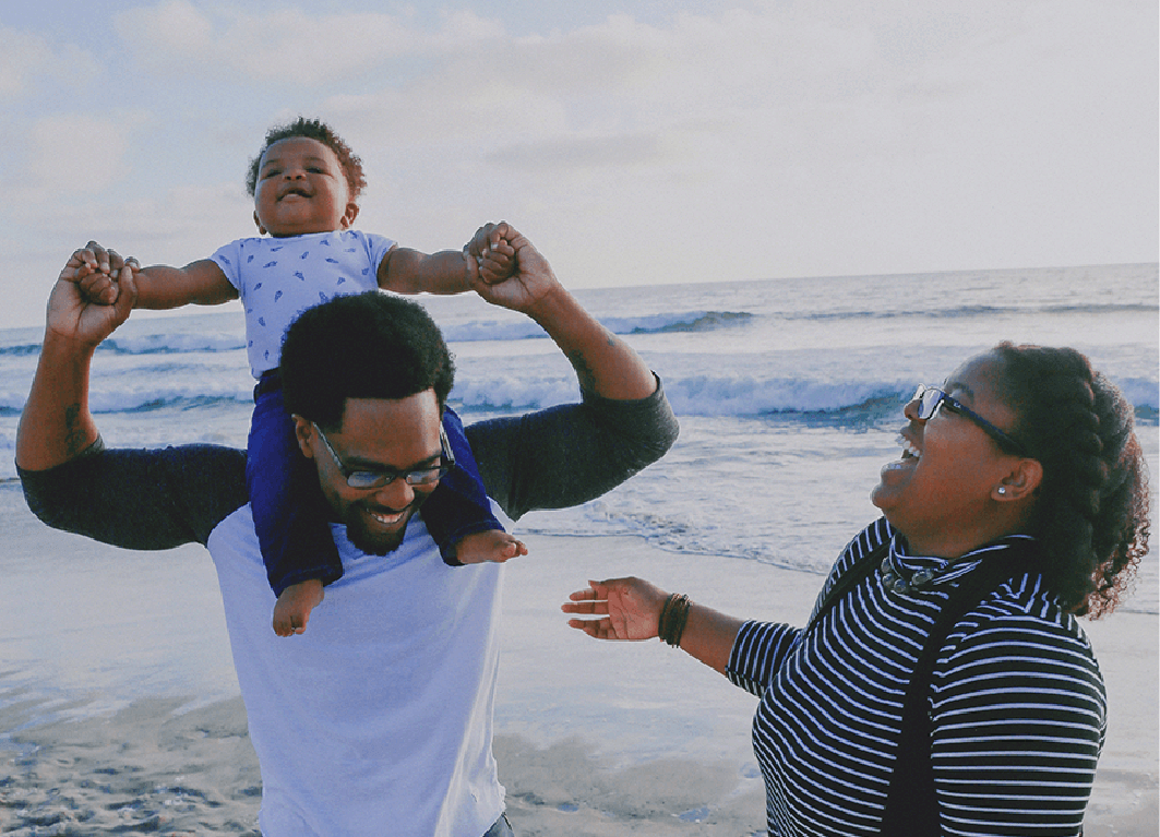 family with baby on a beach
